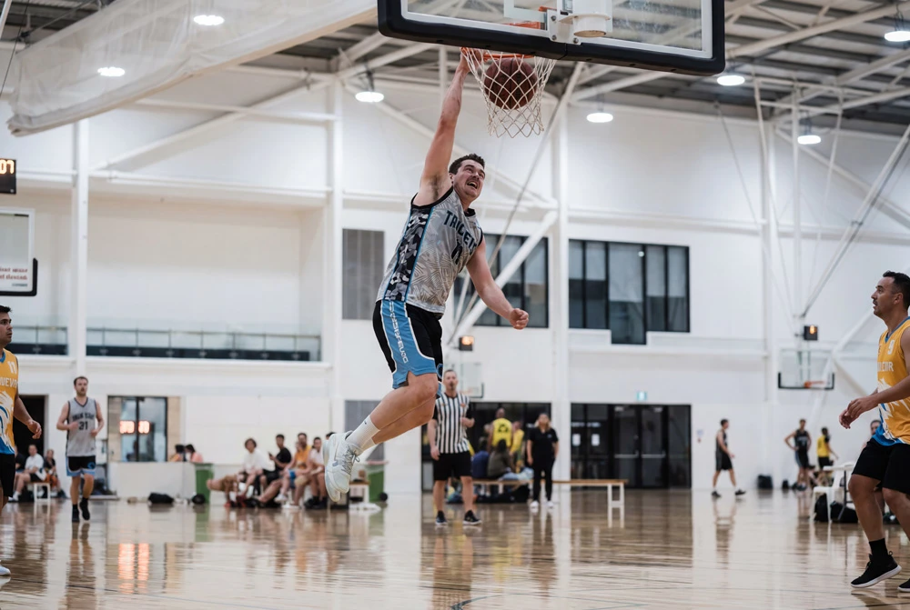 Player rising for a dunk during a Gold Coast basketball game
