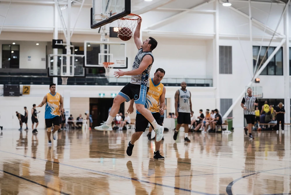 Player driving to the hoop for a layup in a community game