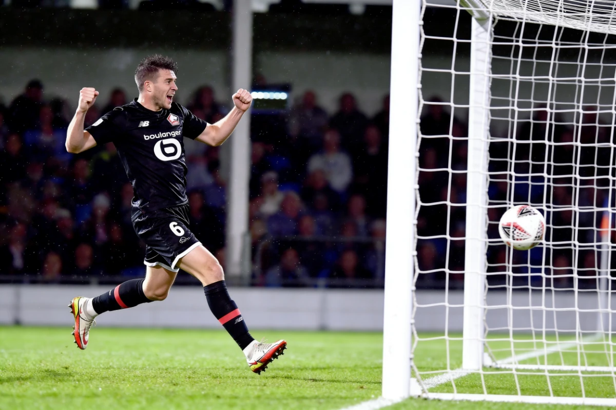 Player celebrating a goal at the net