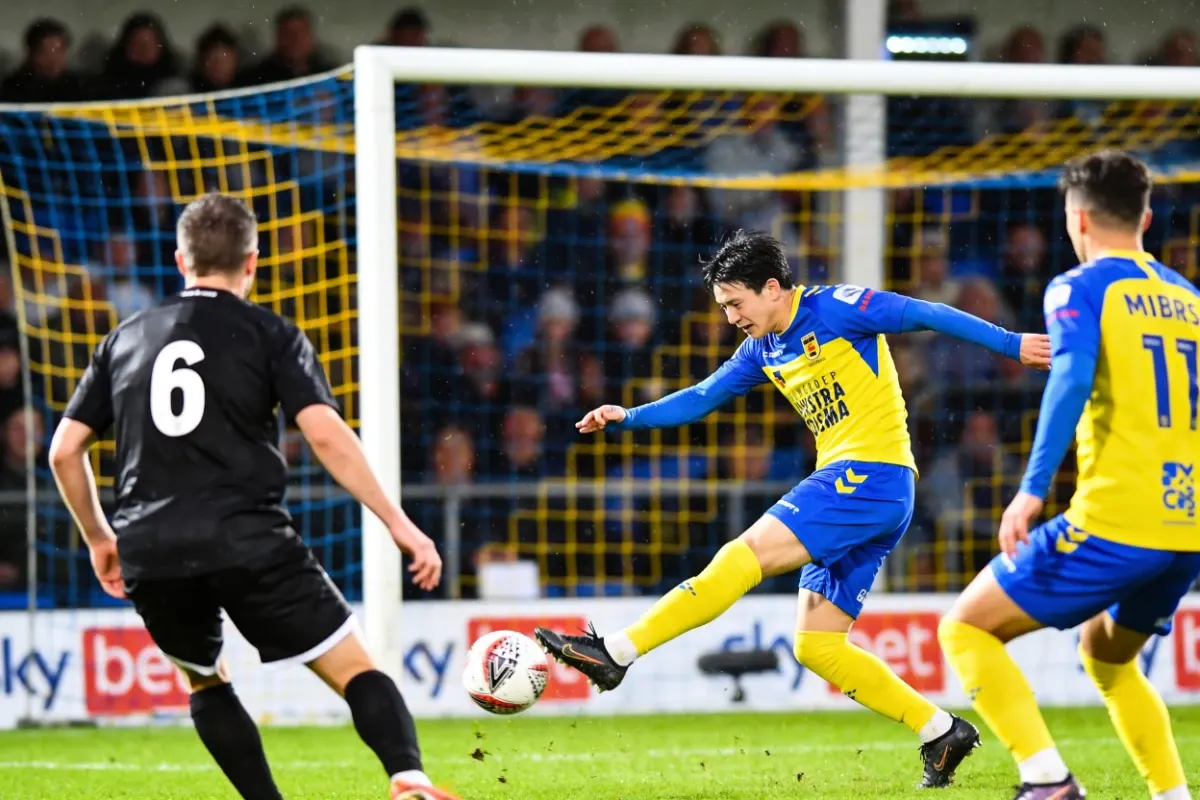 Player striking the ball toward goal