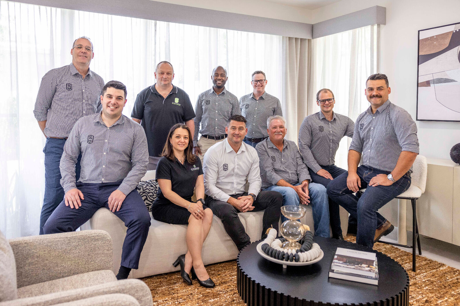 The SW Brokerage team gathered around a table