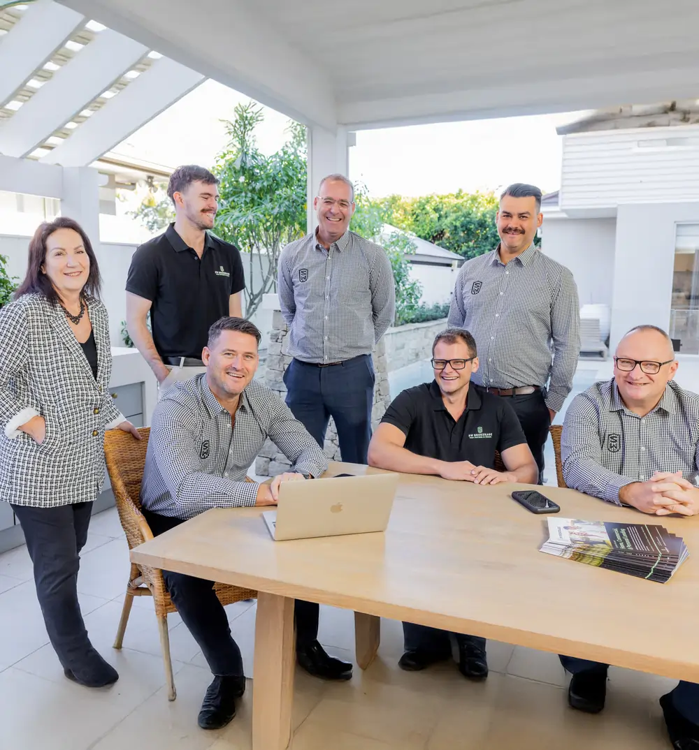 The SW Brokerage team gathered around a table